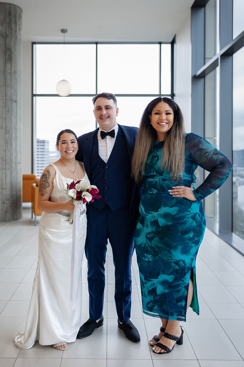 Isabel with a bride and groom at their downtown wedding